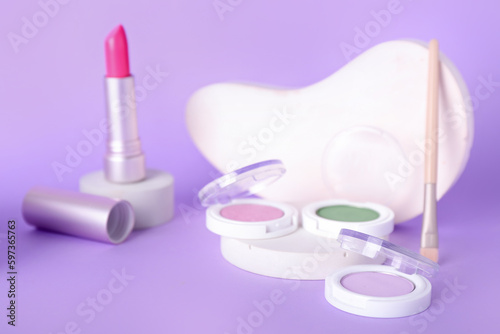 Decorative plaster podiums and cosmetics on lilac background © Pixel-Shot