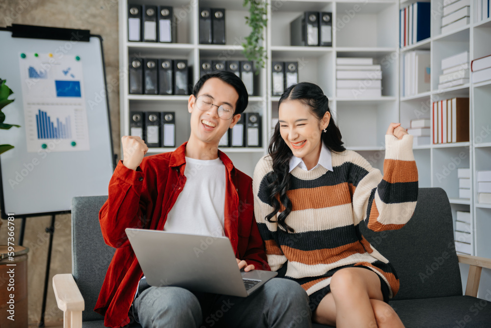 Young Asian business team creative businesspeople coworker, teamwork celebrating achievement and in planning design in office. Young Asian business team creative businesspeople coworker, teamwork celebrating achievement and in planning design in office.