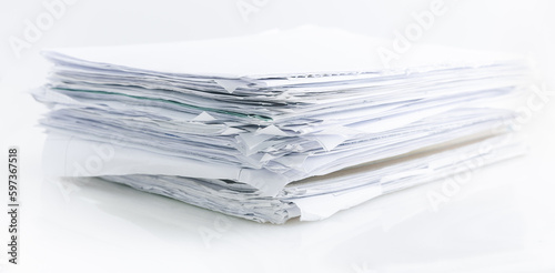 Large pile of waste paper isolated on white, ready for recycling