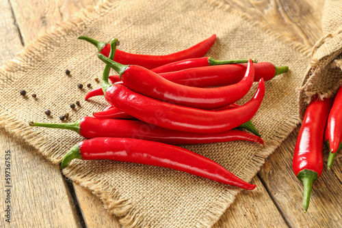 Heap of fresh chili peppers on wooden background