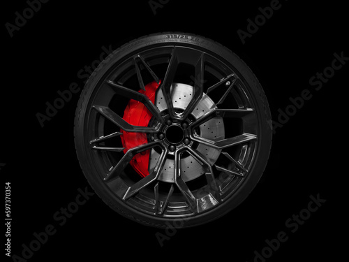 Car alloy wheel and tyre isolated on black background. New alloy wheel with tire and yellow carbon ceramic brakes. Alloy rim isolated. Car wheel disc. Car spare parts..
