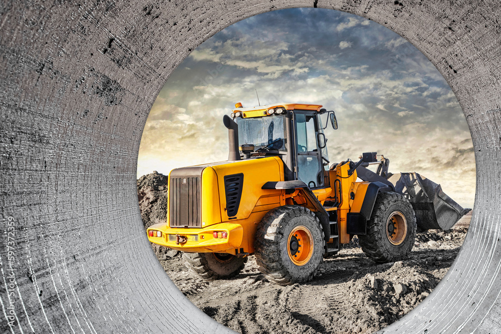 Powerful wheel loader or bulldozer working on a quarry or construction site. Earthworks in construction. Powerful modern equipment for earthworks. Powerful wheel loader or bulldozer working on a quarry or construction site. Earthworks in construction. Powerful modern equipment for earthworks.