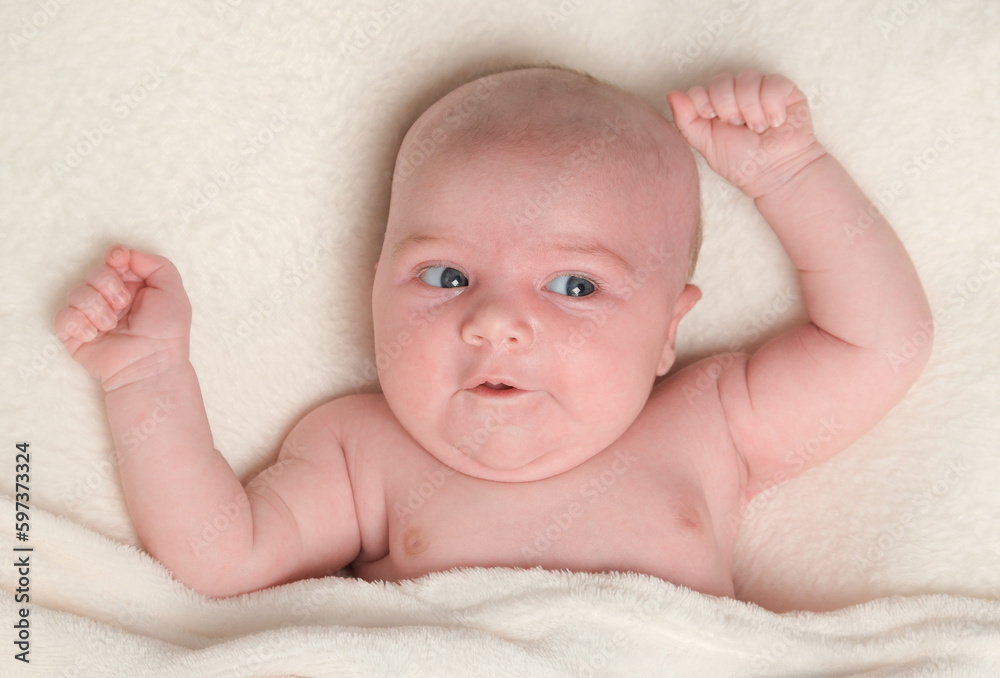Portrait of newborn girl lying on her back, with both arms raised with a cute facial expression. Portrait of newborn girl lying on her back, with both arms raised with a cute facial expression.
