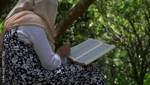 Spiritual Connection: Islamic Women Reading the Holy Quran in Nature photo