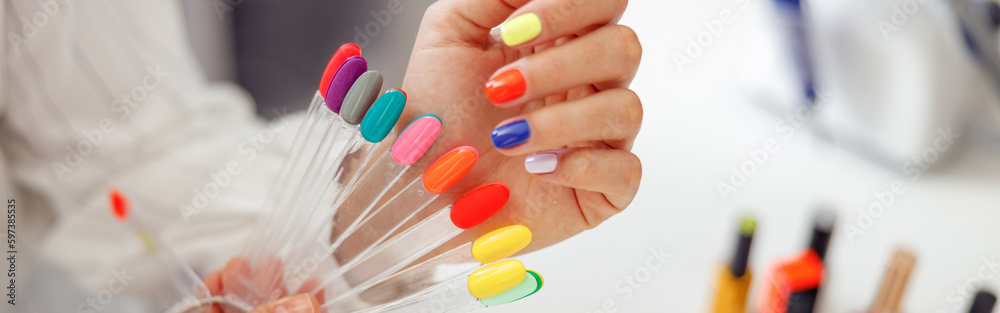 Woman client with palette of nail varnishes in beauty shop Woman client with palette of nail varnishes in beauty shop