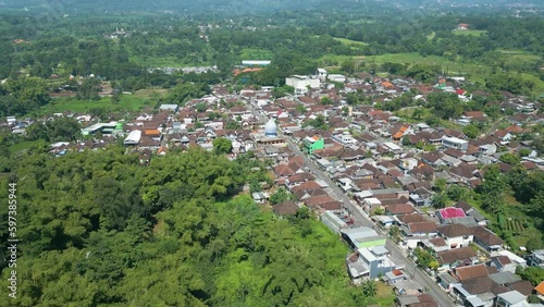 Indonesian village of Pandaan Pasuran, Islamic mosque. scenic flyover push in aerial shot. photo
