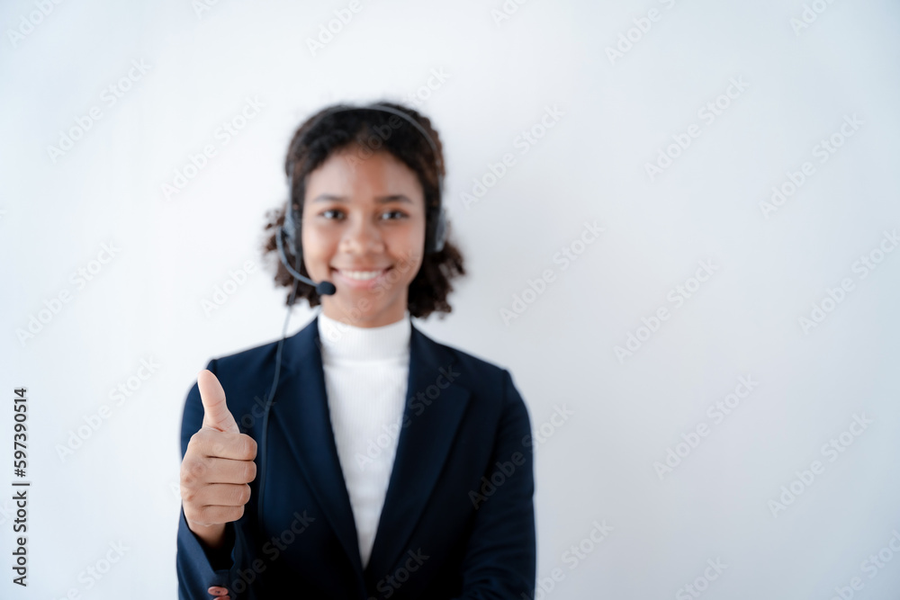 Friendly smiling female call-center agent with headset working on support hotline in office. Friendly smiling female call-center agent with headset working on support hotline in office.