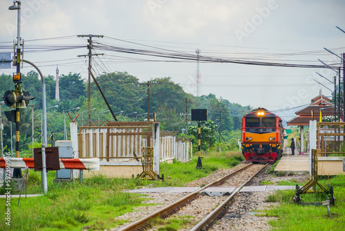 Perspective view of the train is departing from the Wat Chang Hai station, Pattani, South of Thailand. Diesel electric locomotive of State Railway of Thailand