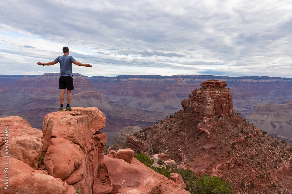 Man with scenic view from Skeleton Point on South Kaibab hiking trail at South Rim, Grand Canyon National Park, Arizona, USA. Colorado River weaving through valleys and rugged terrain. O Neill Butte