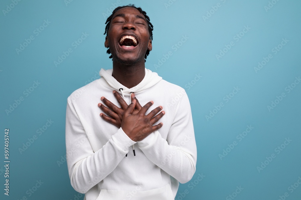 joyful winner african 20s man with dreadlocks on background with copy space joyful winner african 20s man with dreadlocks on background with copy space