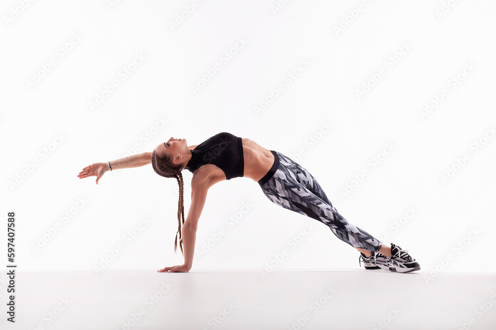 Sports girl doing stretching exercise. White background