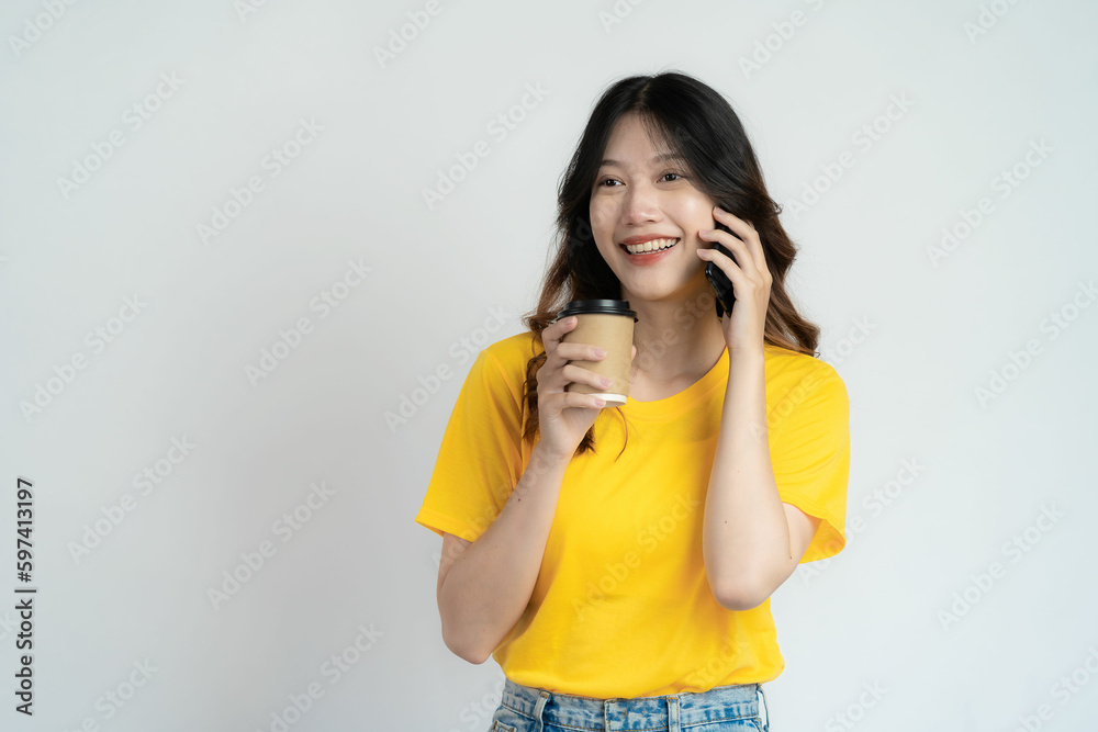 Young Asian woman holding smartphone pops up to chat with friend Black blank white screen on white background can be used for advertising or product presentation. Young Asian woman holding smartphone pops up to chat with friend Black blank white screen on white background can be used for advertising or product presentation.