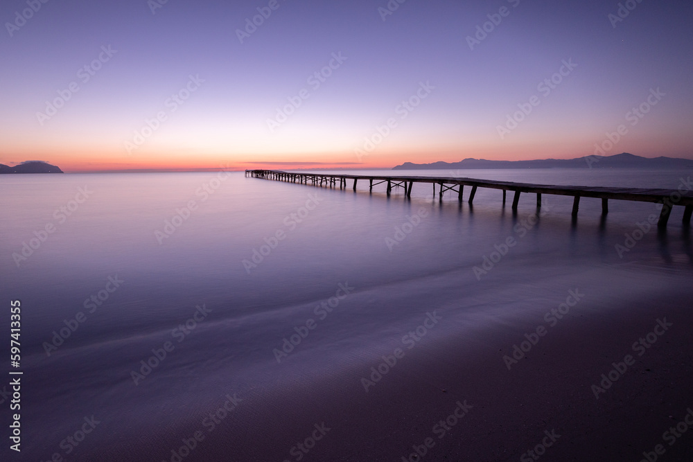pier at the beach during sunrise/sunset pier at the beach during sunrise/sunset