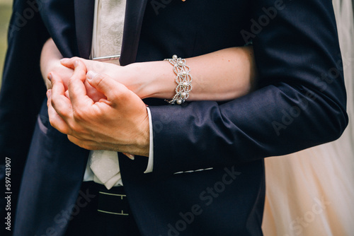 bride and groom holding hands © KatKazz