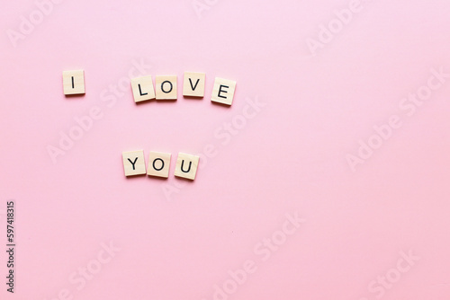 I love you made of wooden letters on a pink background. Flatly i love you. Flat lay valentines day