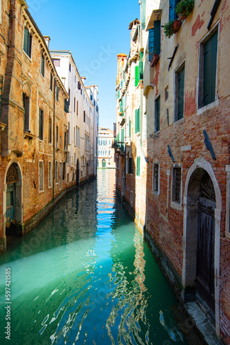 Narrow canals of Venice city with old traditional architecture, bridges and boats, Veneto, Italy. Tourism concept. Architecture and landmark of Venice. Cozy cityscape of Venice.