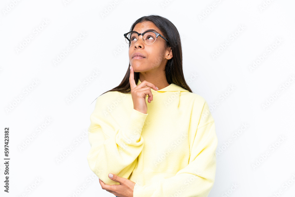 Young African american woman isolated on white background having doubts while looking up Young African american woman isolated on white background having doubts while looking up