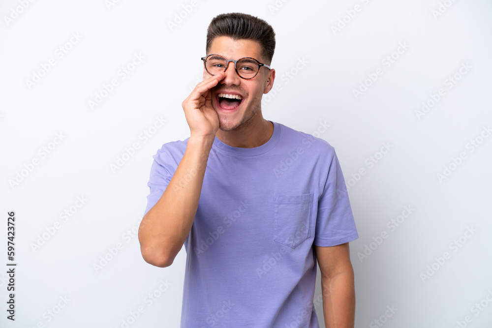 Young caucasian man isolated on white background shouting with mouth wide open Young caucasian man isolated on white background shouting with mouth wide open