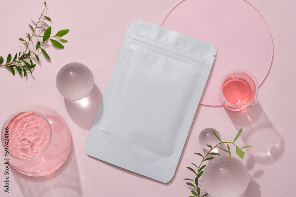 Mockup of a facial sheet mask package on pastel pink background with ...