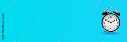 Black alarm clock over turquoise blue background with copy space. Time management concept.