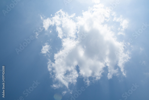 blue sky with white cloud and sunlight background.