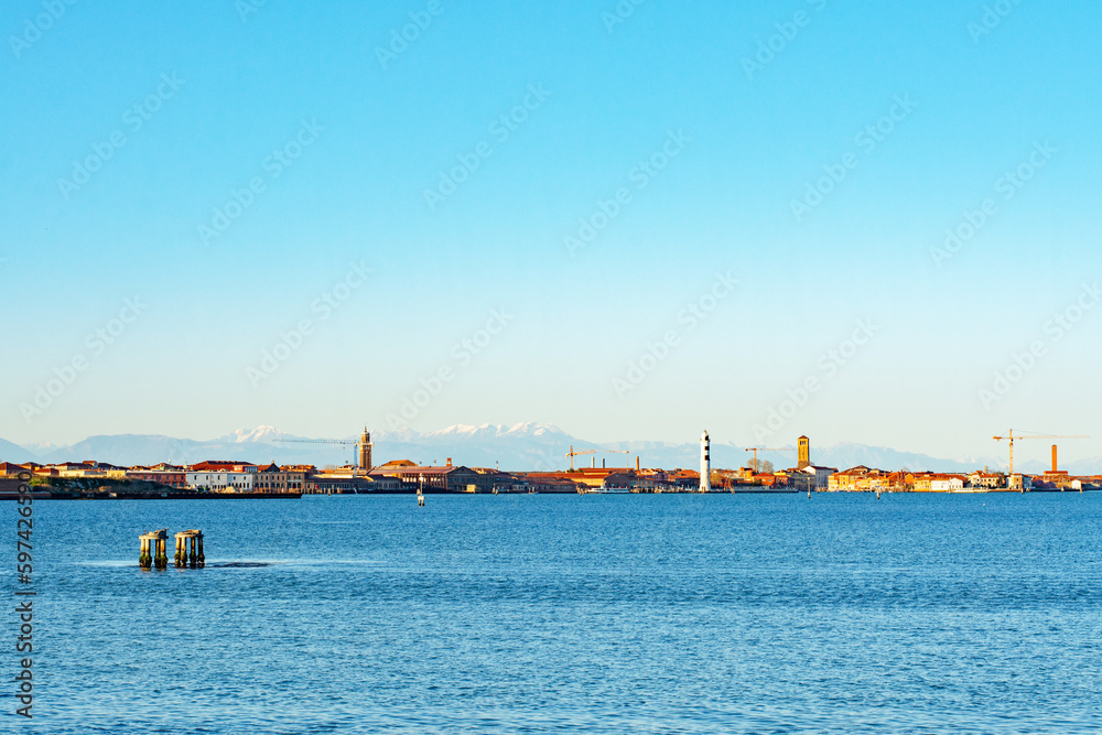 Beautiful picturesque panoramic view of Venice Mestre and snowy mountains from Venice embankment. Italy