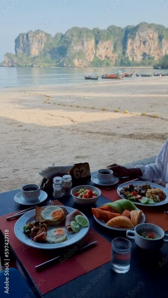 women having Breakfast at a luxury hotel on the beach of Railay Krabi Thailand. 