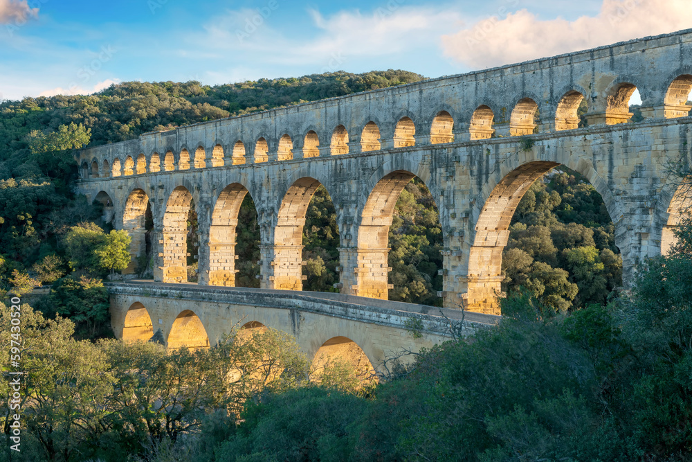 The "Pont du Gard" is an ancient Roman aqueduct bridge built in the first century AD to carry water (31 mi) .It was added to UNESCO's list of World Heritage  Sites in 1985 - obrazy, fototapety, plakaty 