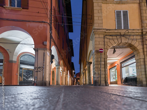 Bologna's street by night with the famous unesco porticoes photo