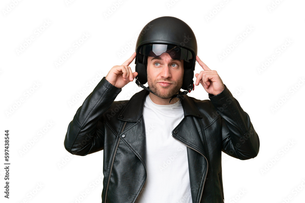 Young caucasian man with a motorcycle helmet isolated on green chroma background having doubts and thinking Young caucasian man with a motorcycle helmet isolated on green chroma background having doubts and thinking