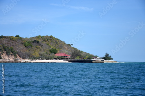 A house on the sea beach in Ko Lan Island, Pattaya, Thailand. where relaxation can be felt. March, when spring has not come yet. Wooden House with hill and sea beach.