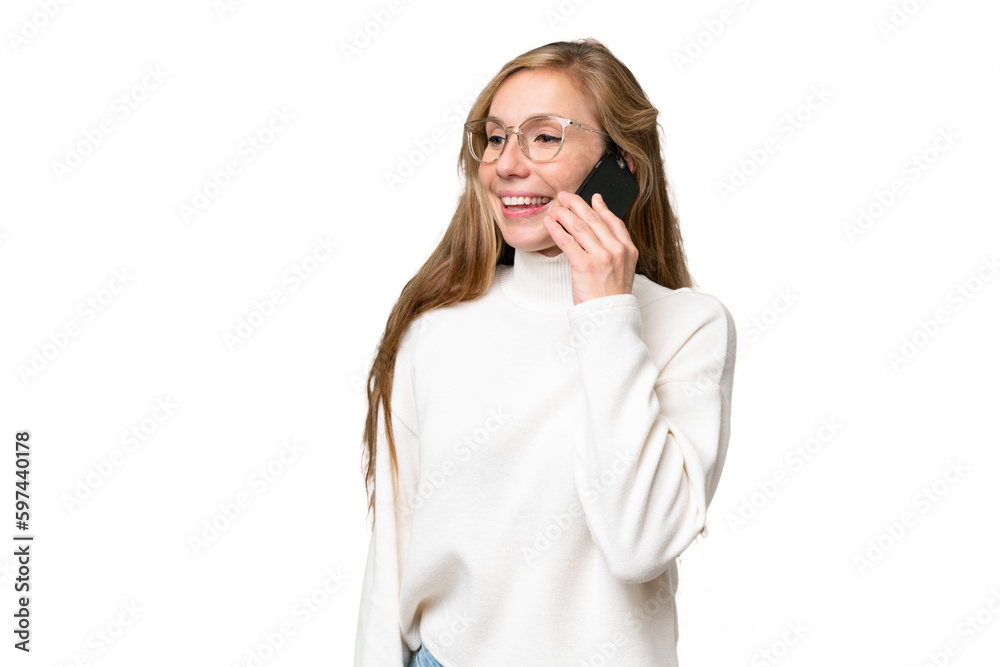 Young blonde woman over isolated background keeping a conversation with the mobile phone with someone Young blonde woman over isolated background keeping a conversation with the mobile phone with someone