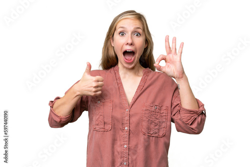 Young blonde woman over isolated background showing ok sign and thumb up gesture