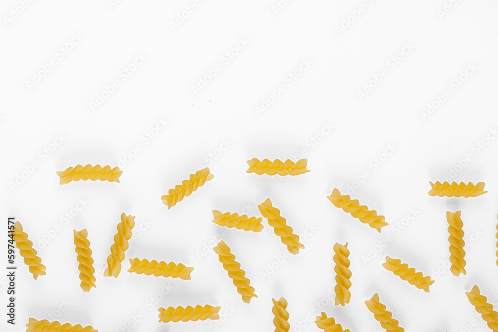 Pasta products in the form of a spiral, texture, on a white background Pasta products in the form of a spiral, texture, on a white background