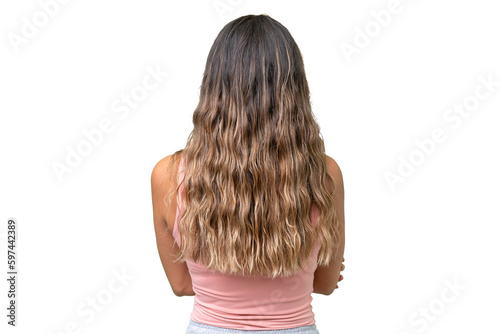 Young caucasian woman over isolated background in back position