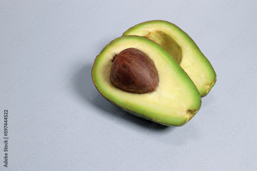 Sliced avocado on a gray background, the concept of weight loss, proper nutrition