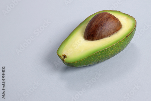 Sliced avocado on a gray background, the concept of weight loss, proper nutrition