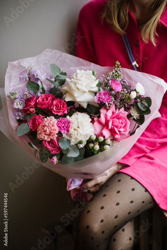 Wallpaper Mural Girl dressed in pink holding luxurious beautiful flower bouquet of fresh roses, carnations, eucalyptus flowers in pink and white colors  Torontodigital.ca