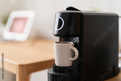 capsule coffee machine while preparing an espresso photo