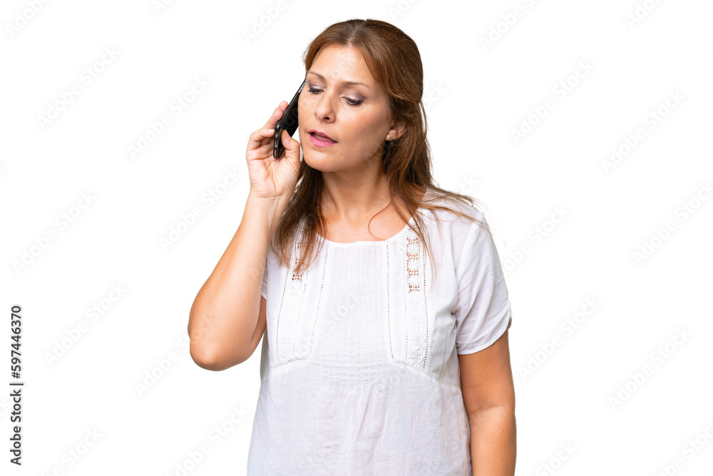 Middle-aged caucasian woman over isolated background keeping a conversation with the mobile phone Middle-aged caucasian woman over isolated background keeping a conversation with the mobile phone