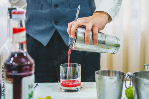 barman pouring liquid into glass