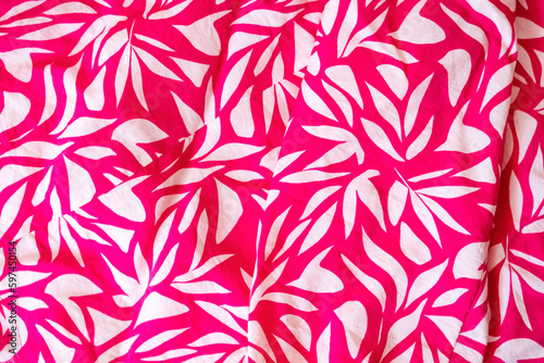 Magenta floral cloth pattern for background and with copy space. Beautiful floral design on magenta blouse textured. Vintage design. Close up photo. Summer vibes.