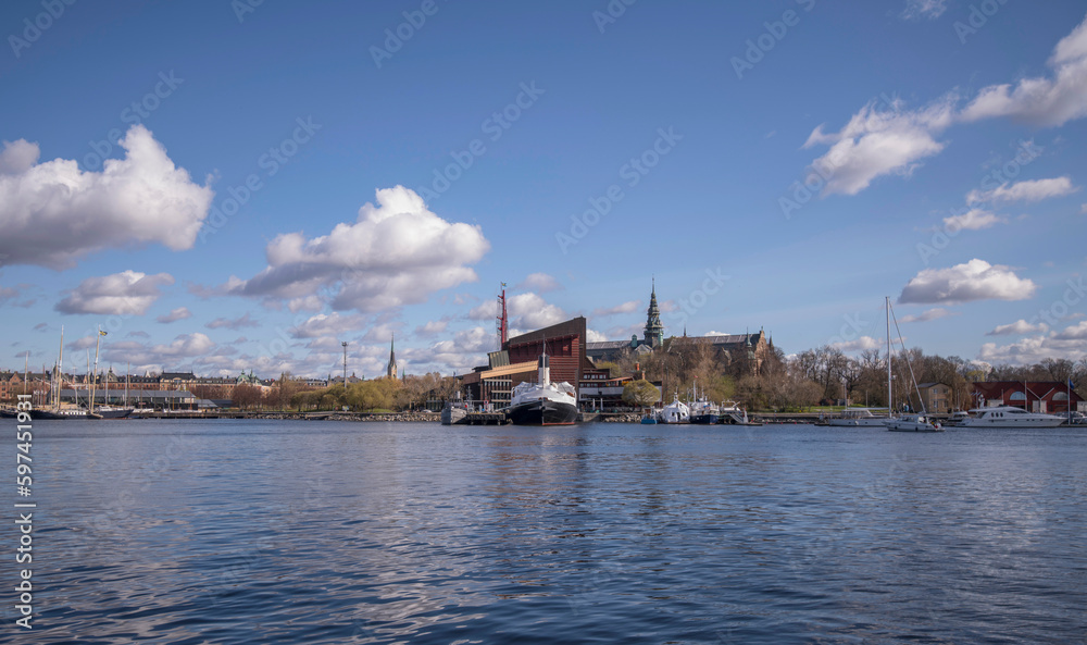Panorama over the bay Ladugårdsviken, in background the maritime museum boats and the Vasa museum, a sunny spring day with cumulus clouds in Stockholm