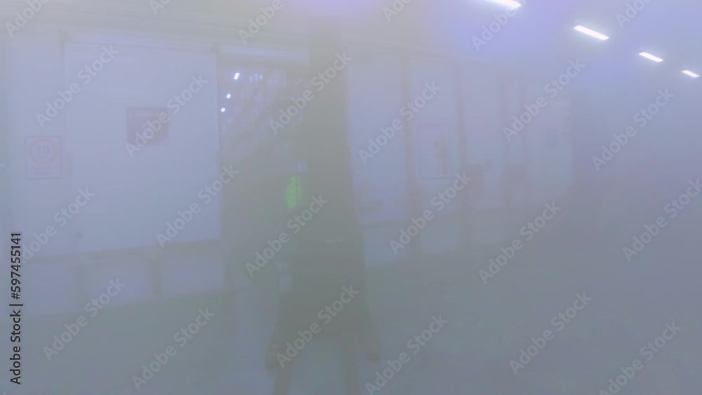 Forklift driving in hazy freezer of maritime distribution warehouse. FPV drone Forklift driving in hazy freezer of maritime distribution warehouse. FPV drone