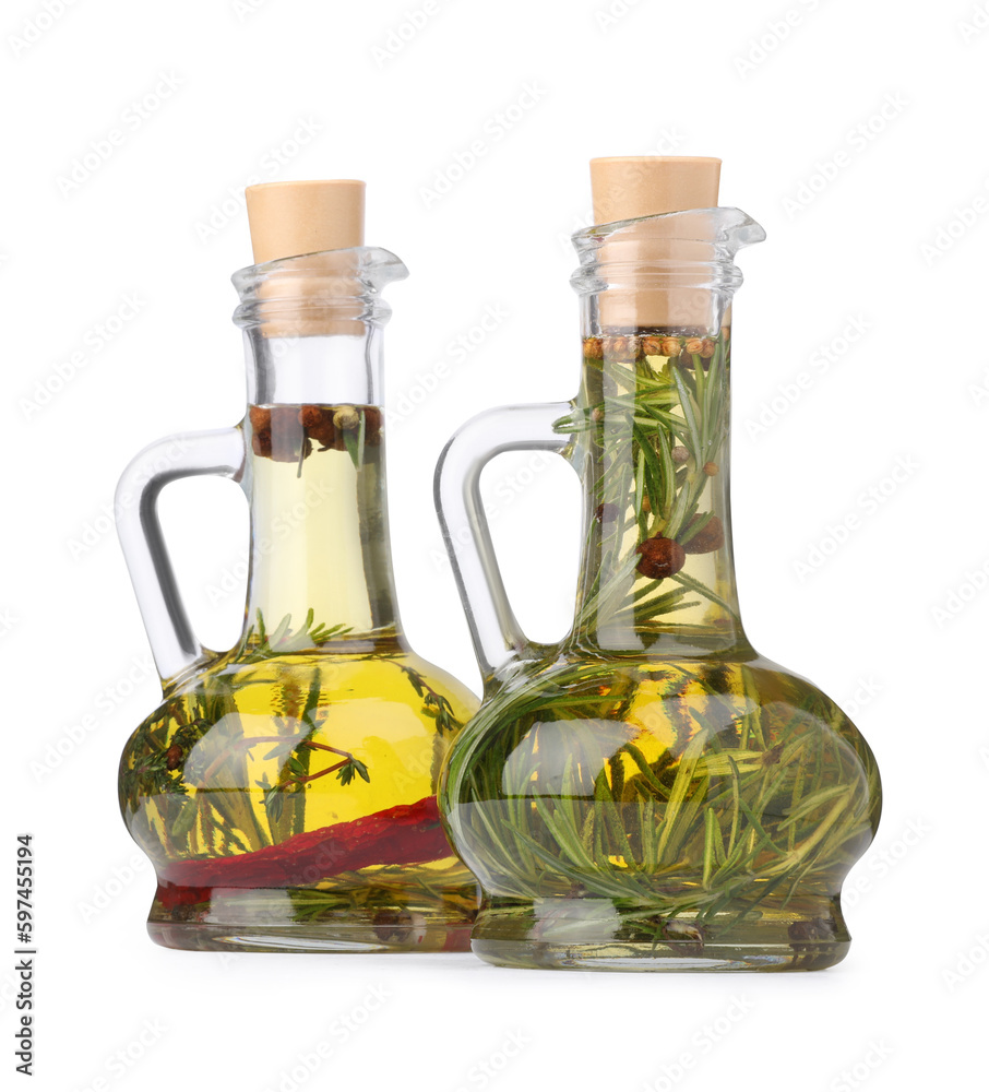 Glass jugs of cooking oils with spices and herbs on white background Glass jugs of cooking oils with spices and herbs on white background