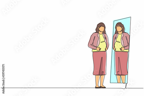 Continuous one line drawing businesswoman standing in front of mirror and see herself getting big belly with holding her stomach. Oversized and obesity concept. Single line draw design vector graphic