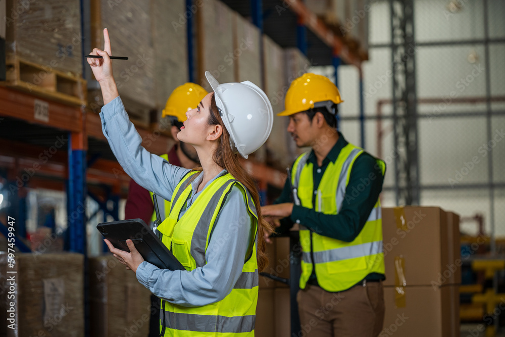 Warehouse worker checking in warehouse,This is a freight transportation and distribution warehouse. Industrial and industrial workers concept. Warehouse worker checking in warehouse,This is a freight transportation and distribution warehouse. Industrial and industrial workers concept.