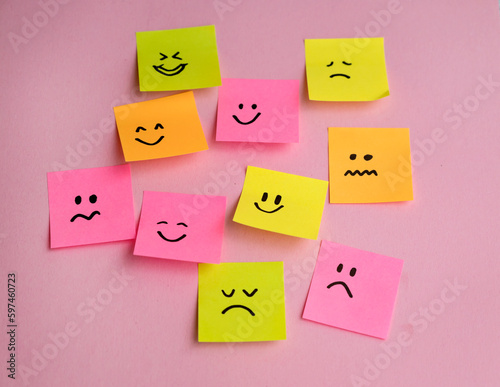 Many sticky notes with different emotions on pink background . Empathy Concept  