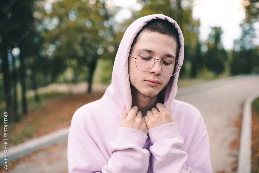 Stylish handsome teenage boy 1516 year old wear glasses and pink