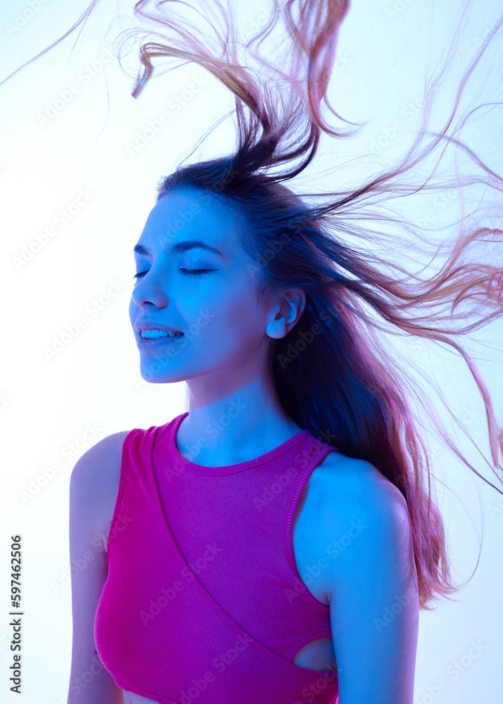 beautiful woman with flowing hair in neon lighting in fashionable summer clothes beautiful woman with flowing hair in neon lighting in fashionable summer clothes